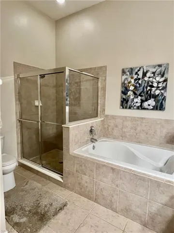 Closer view of shower and tub before accessories were removed