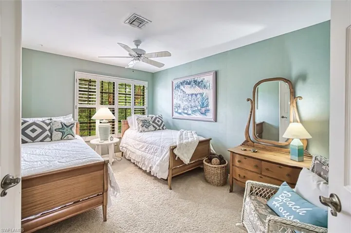 Carpeted bedroom with ceiling fan