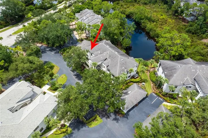 Aerial view of residential area featuring a nearby body of water