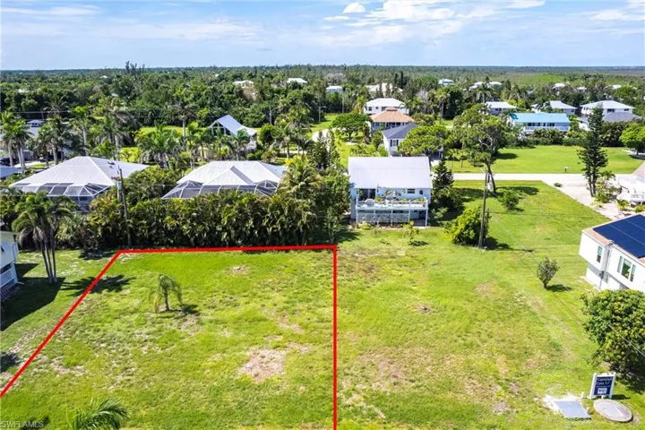 Aerial view of residential area featuring property boundaries highlighted
