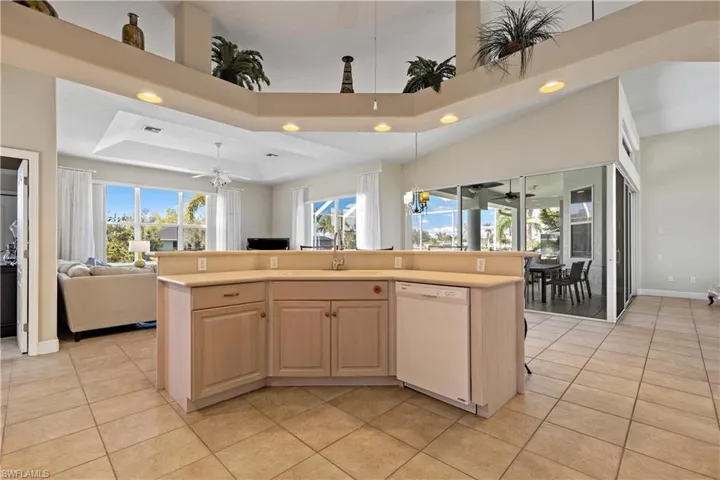 Kitchen with a center island with sink, dishwasher, and stunning views of the pool