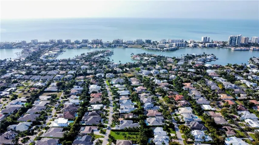 Aerial overview of property's location featuring nearby urban area and a large body of water