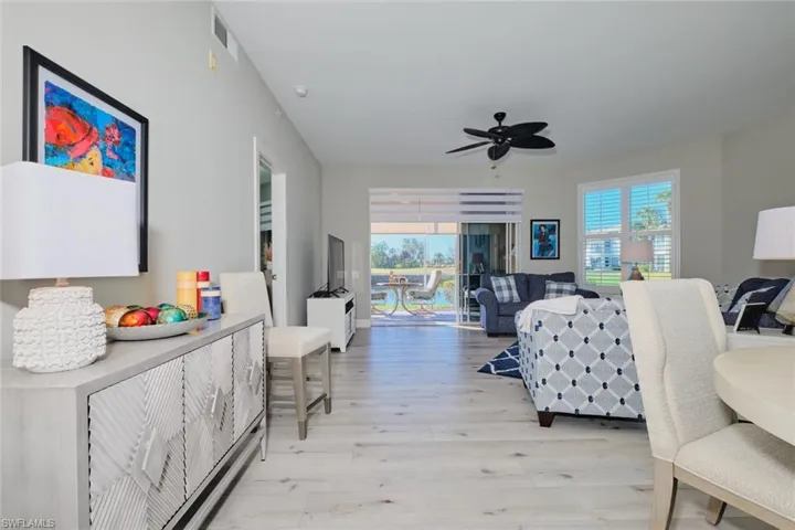 Living room featuring ceiling fan and light hardwood / wood-style flooring