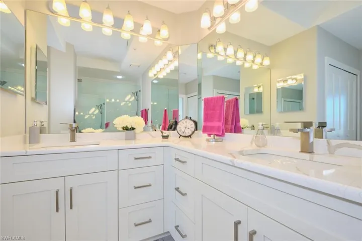 Bathroom with vanity and a shower with door