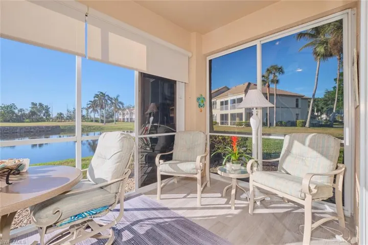 Sunroom featuring a water view and plenty of natural light