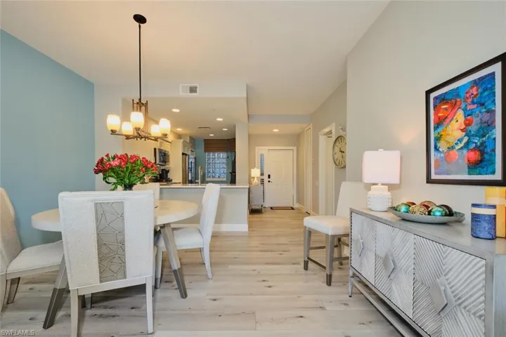Dining area with a chandelier, sink, and light hardwood / wood-style flooring