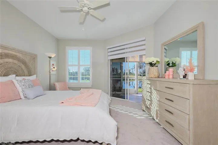 Bedroom featuring carpet, access to outside, multiple windows, and ceiling fan