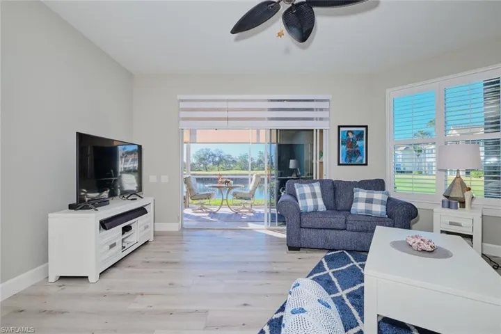Living room with plenty of natural light, ceiling fan, and light hardwood / wood-style flooring