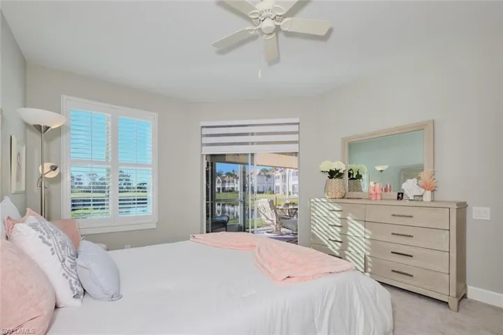 Carpeted bedroom with access to outside and ceiling fan