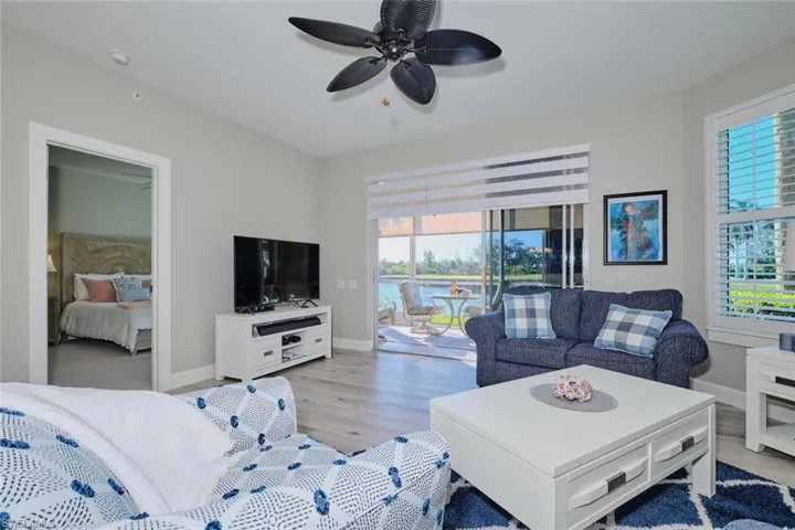 Living room featuring ceiling fan, light hardwood / wood-style floors, and a wealth of natural light