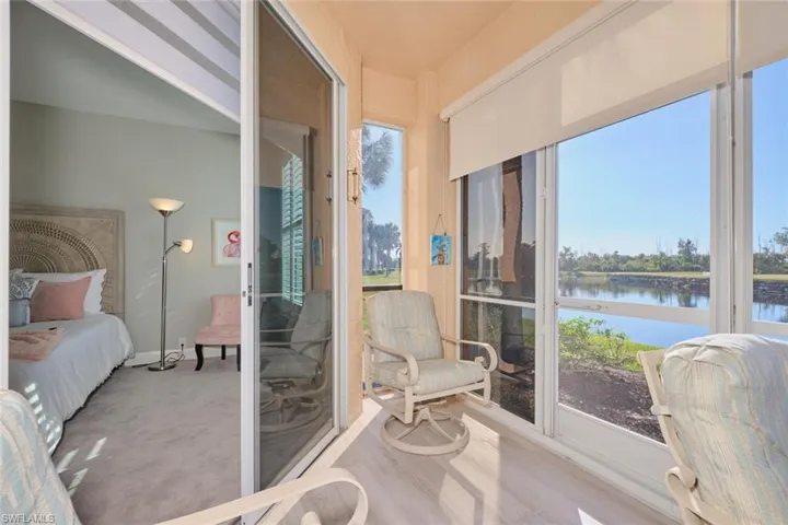 Sunroom featuring a wealth of natural light and a water view