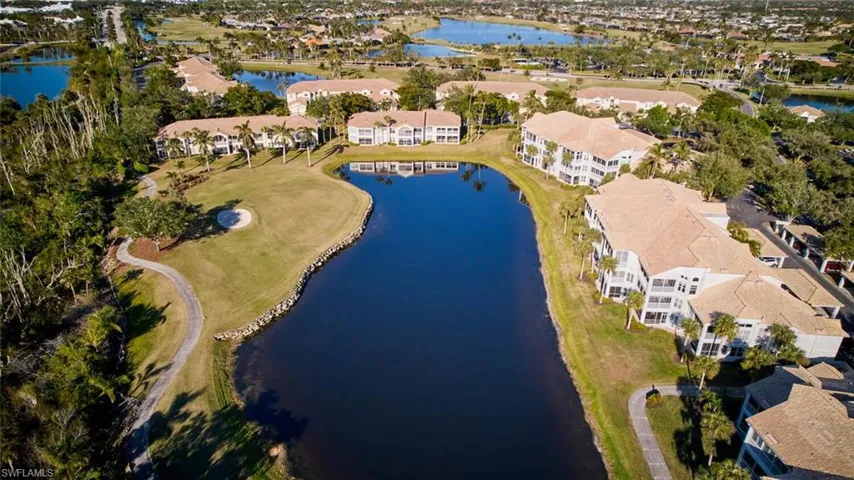Birds eye view of property with a water view