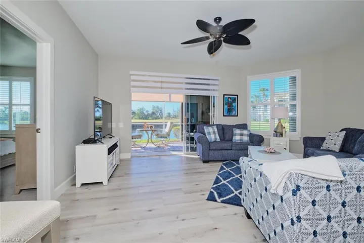 Living room featuring ceiling fan and light wood-type flooring