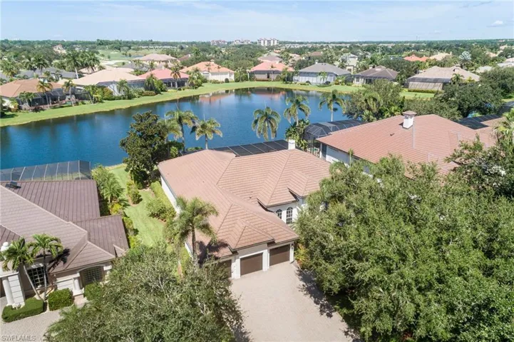 Aerial perspective of suburban area with a nearby body of water