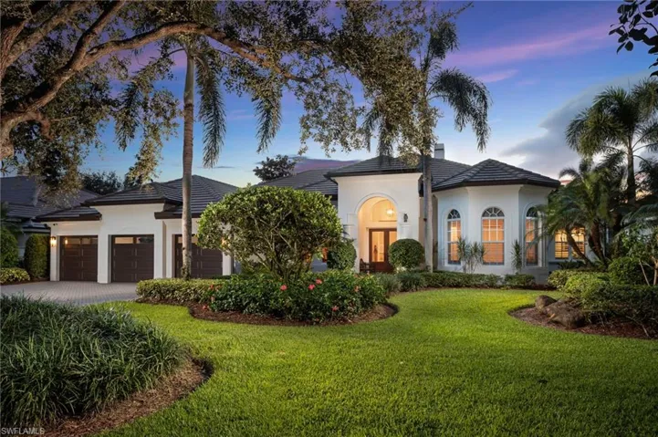 Mediterranean / spanish home featuring a front lawn, an attached garage, stucco siding, decorative driveway, and a tiled roof