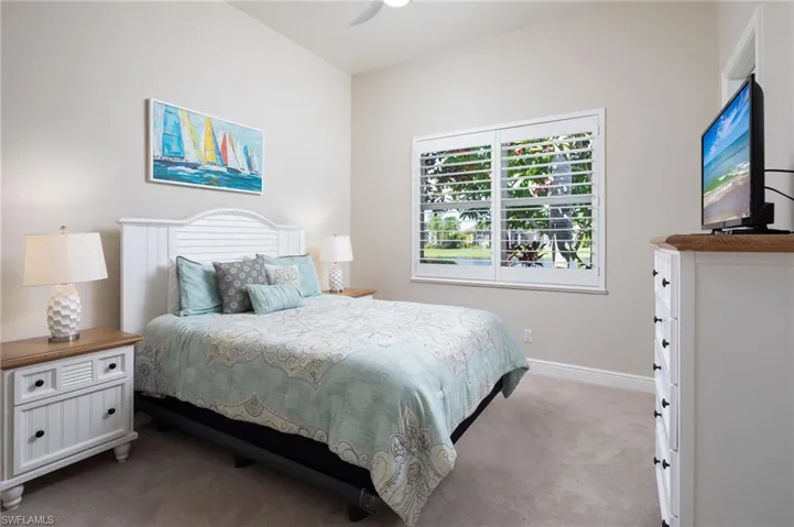 Carpeted bedroom with baseboards and ceiling fan