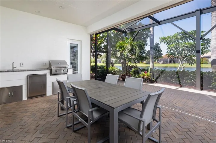 Sunroom / solarium with a water view and a sink