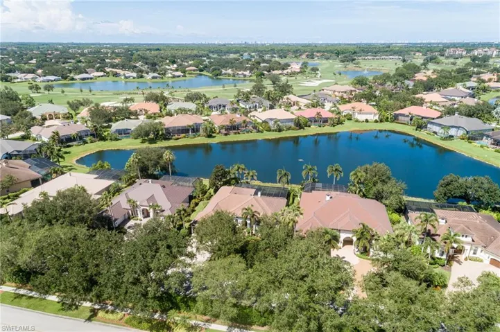 Aerial perspective of suburban area featuring a large body of water