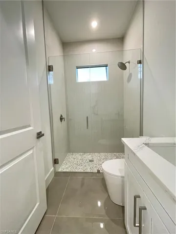 Bathroom with vanity, toilet, and walk in shower