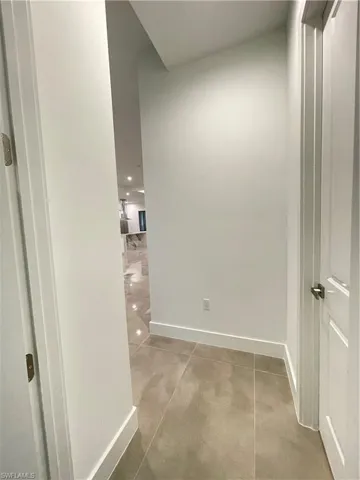 Hallway featuring concrete floors