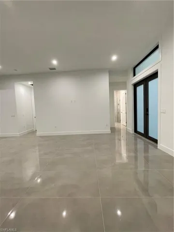 Unfurnished room featuring french doors