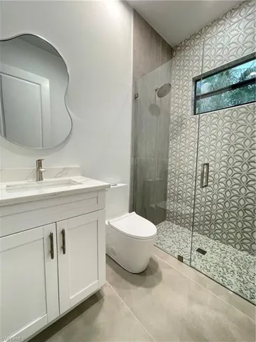 Bathroom with vanity, toilet, and walk in shower