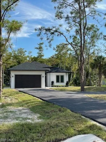Garage featuring a lawn