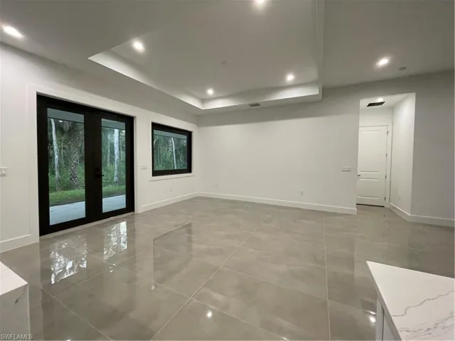 Spare room with a raised ceiling and french doors
