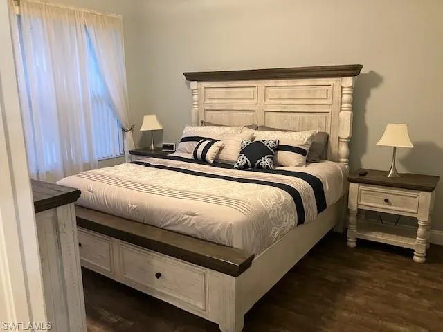 Bedroom with dark wood-style flooring