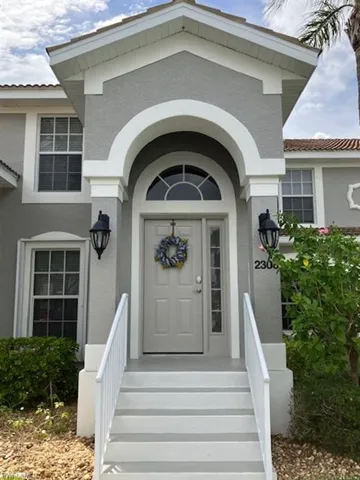 View of exterior entry featuring stucco siding