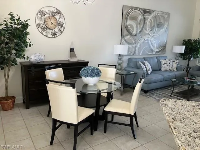 Dining area with light tile patterned flooring