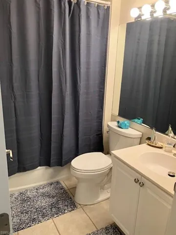 Bathroom with tile patterned floors, toilet, and vanity