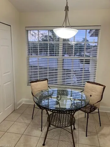 Dining space featuring light tile patterned floors and baseboards