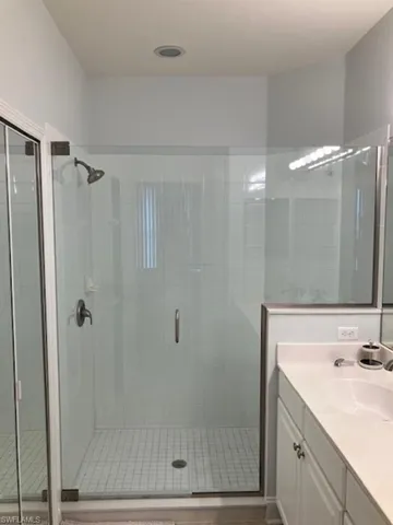 Bathroom with vanity and a frameless glass shower