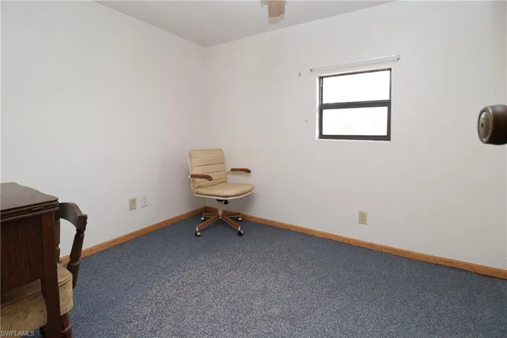 Living area featuring carpet and baseboards