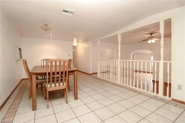 Dining area featuring light tile patterned floors and a ceiling fan