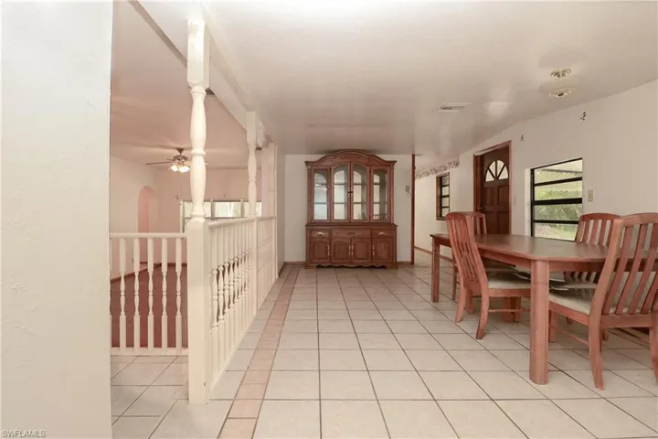 Dining space with light tile patterned floors and a ceiling fan