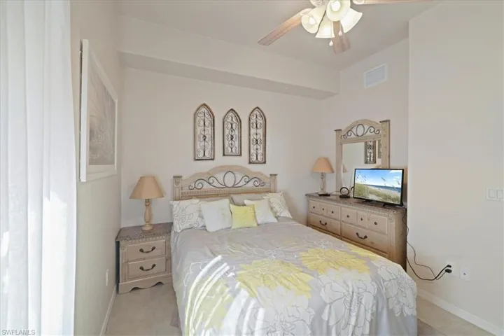 Bedroom featuring a ceiling fan and baseboards