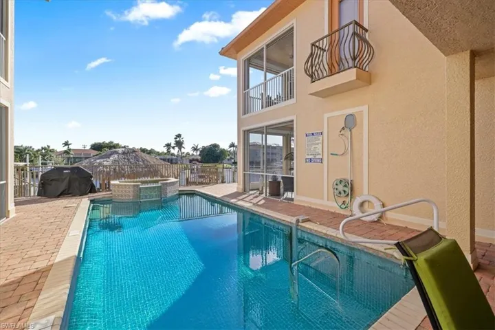Integrated pool / spa with a balcony, a patio, area for grilling, and a fenced backyard