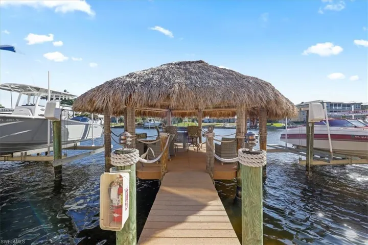 Dock featuring boat lift and a water view