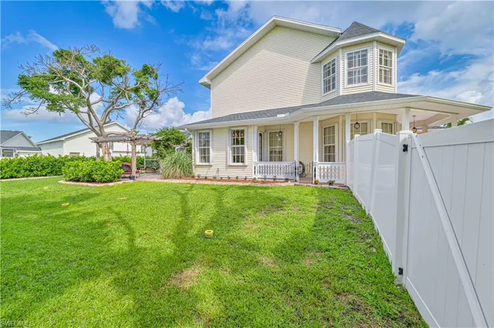 View of front facade featuring a pergola, a porch, and a front lawn