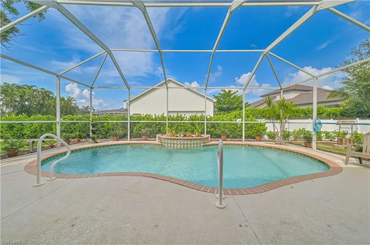 View of swimming pool with a lanai and a patio