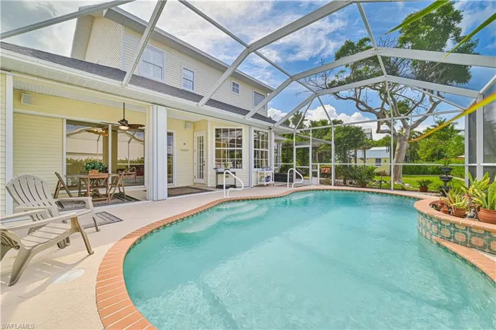 View of pool with ceiling fan, a patio area, and a lanai