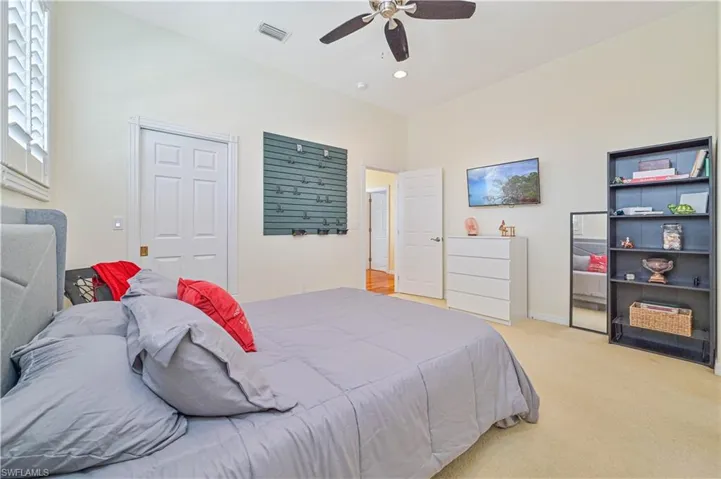 Carpeted bedroom with ceiling fan