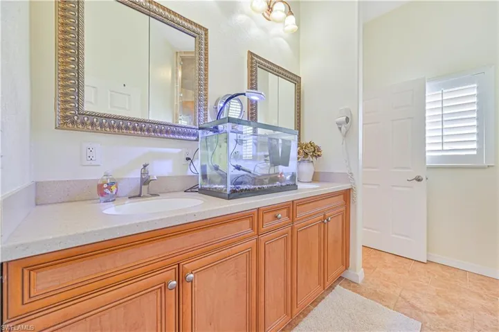 Bathroom featuring tile patterned flooring and dual bowl vanity