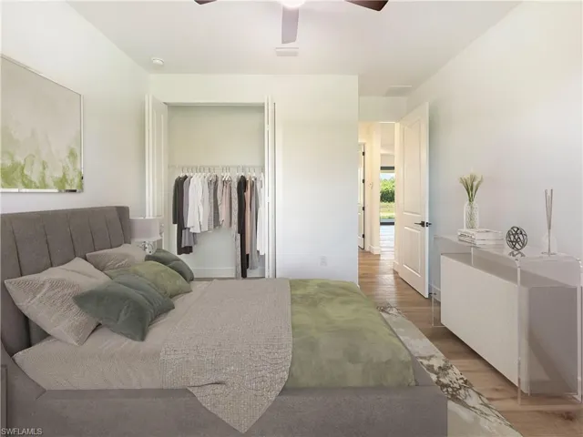 Bedroom featuring a closet, wood-type flooring, and ceiling fan. Virtually staged