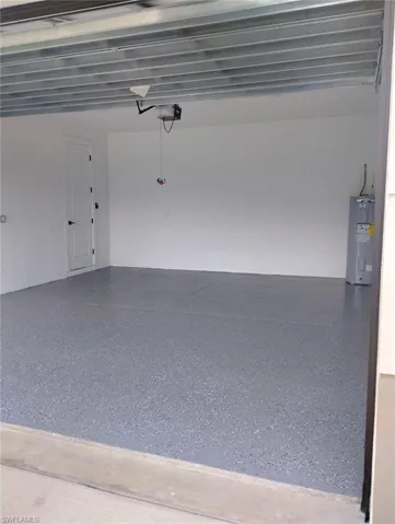 Garage with a garage door opener , epoxy floor, electric water heater