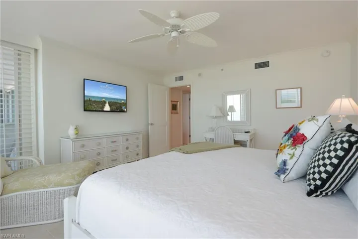 Bedroom with ceiling fan and crown molding
