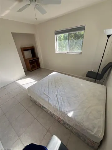 Bedroom with tile patterned flooring and a ceiling fan
