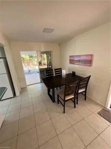 Dining space featuring light tile patterned flooring and baseboards
